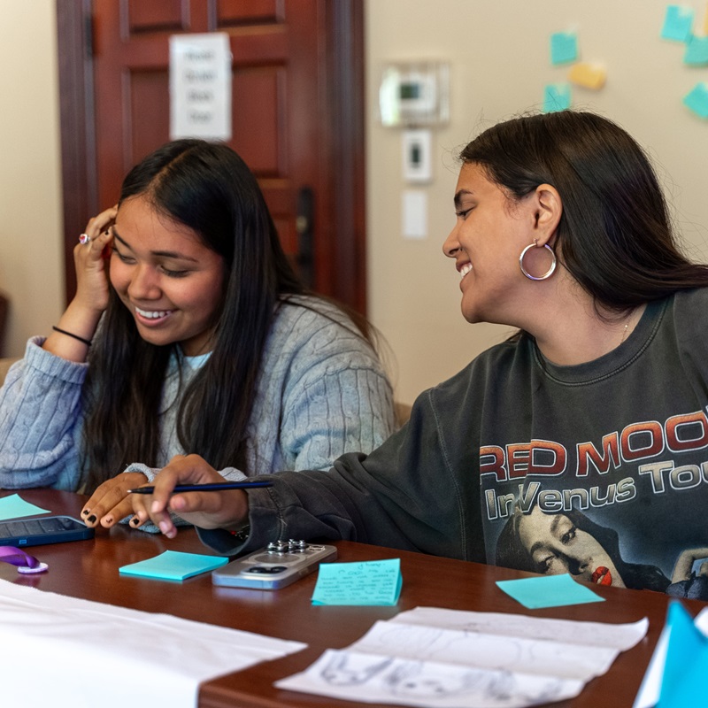 This is an image of Two National Teen Board members hugging and smiling at the camera.